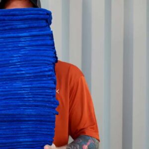a Spark employee holds a stack of microfiber towels - Spark